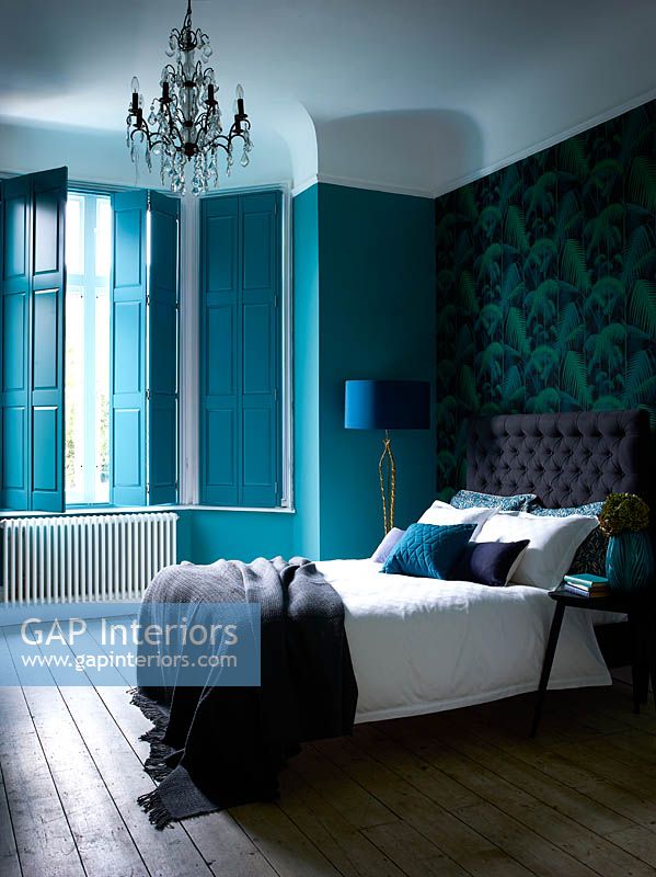 Turquoise shutters at bedroom window