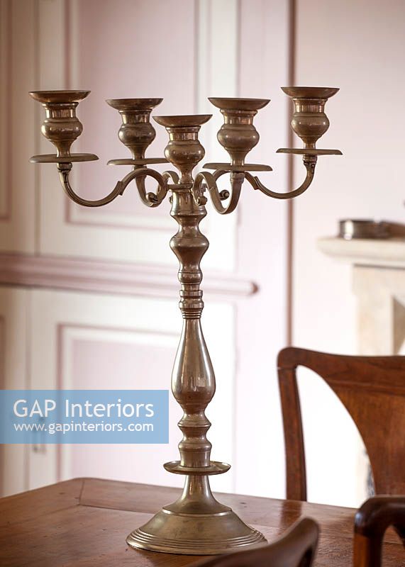 Pewter candelabra on antique dining table