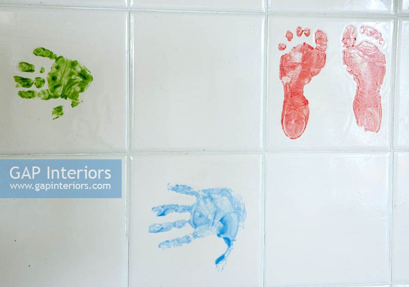Foot and handprints on tiles in kitchen