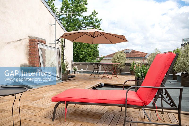 Red lounger on roof terrace