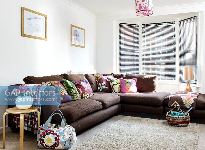 Brown corner sofa with patterned cushions