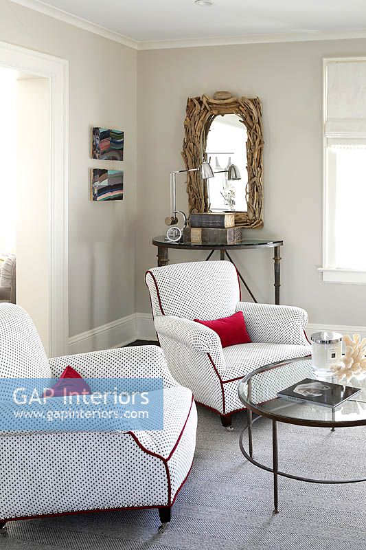White armchairs with red cushions