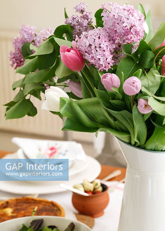 Jug of Tulips and Hyacinth flowers on dining table