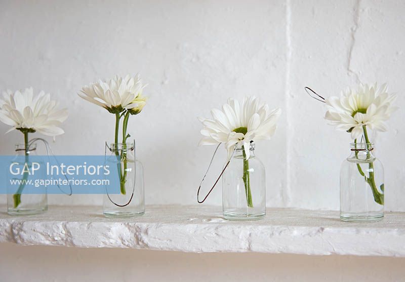 White flowers in glass bottles
