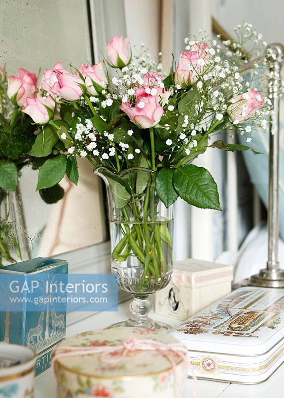 Vase of Roses and Babys breath flowers