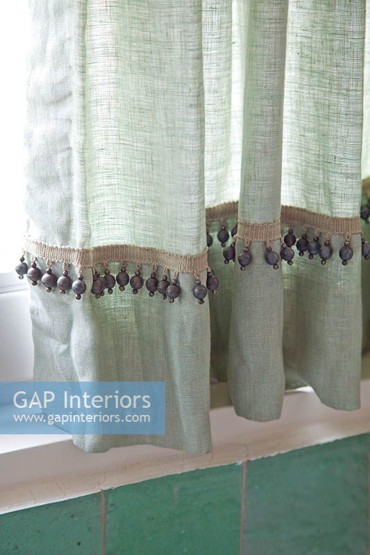 Green curtains in bathroom