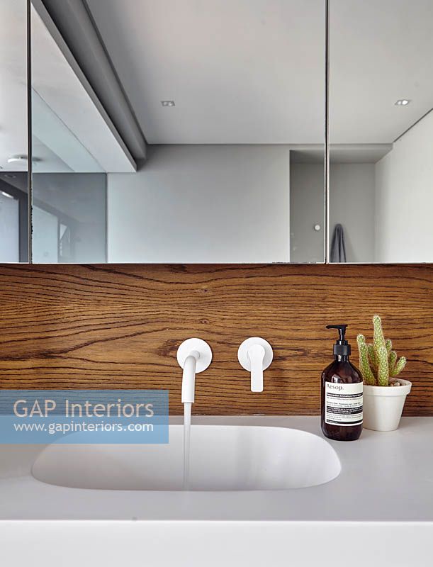 Modern bathroom sink with wooden splashback
