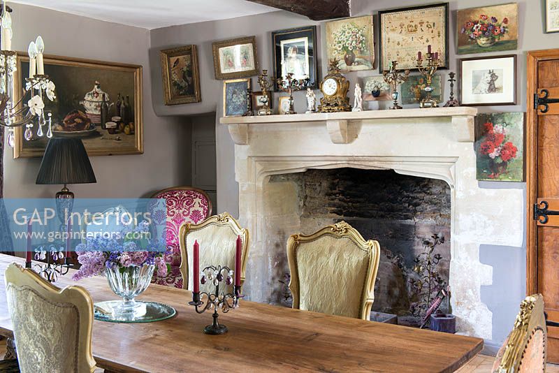 Display of paintings above fireplace