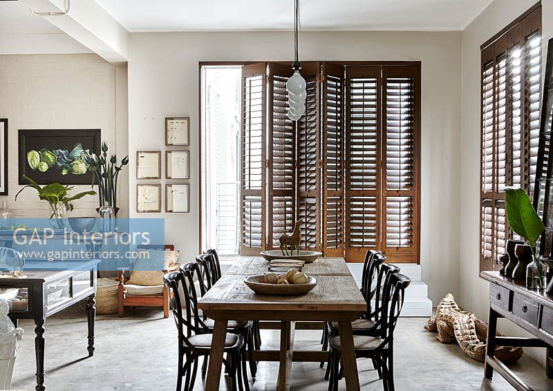 Open plan dining area with wooden shutters