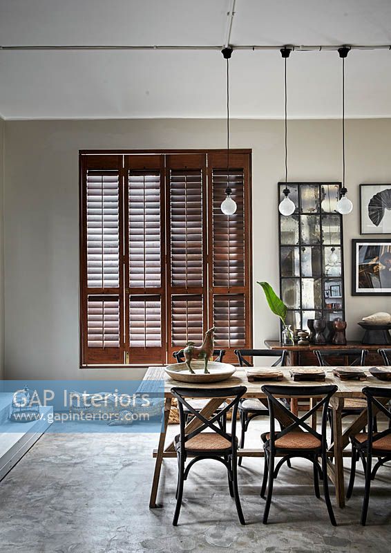 Open plan dining area with wooden shutters
