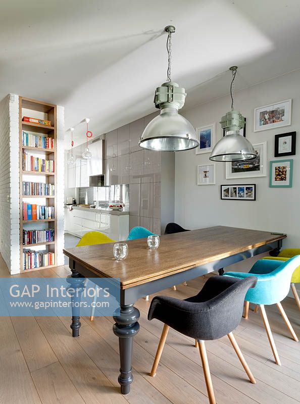 Open plan dining area with colourful chairs