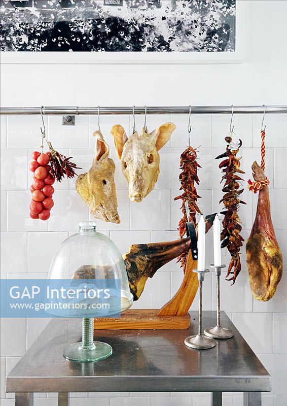 Meats hanging from kitchen rail