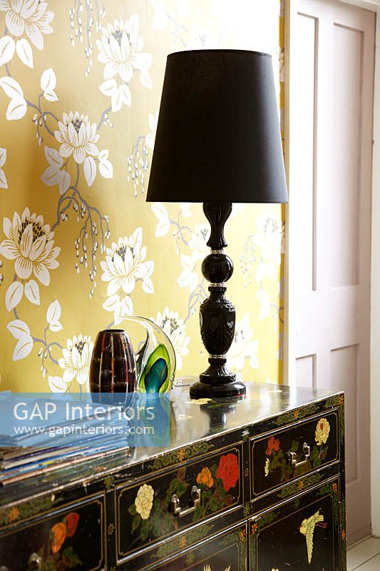 Black lamp on patterned cabinet