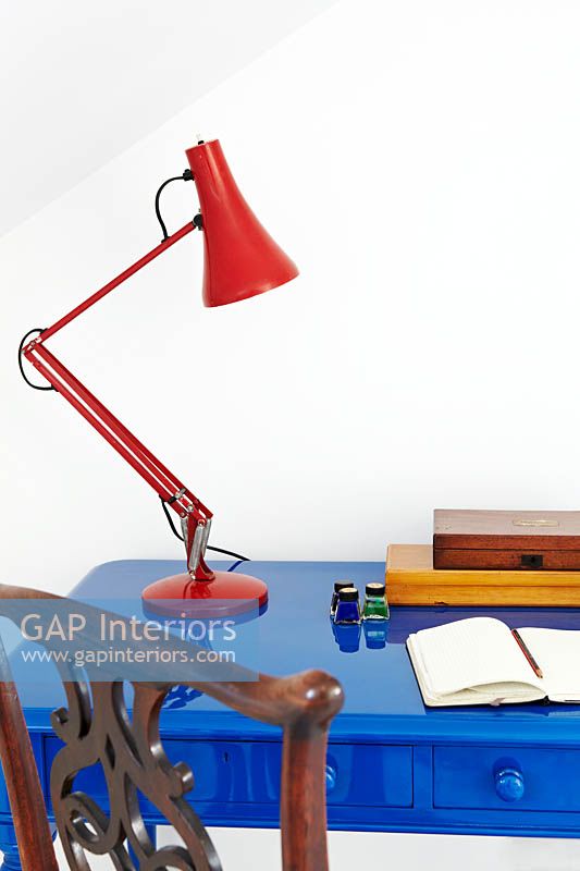 Red lamp on blue desk