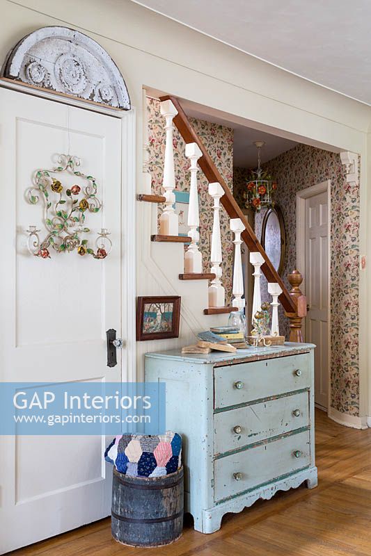 Blue chest of drawers by stairs