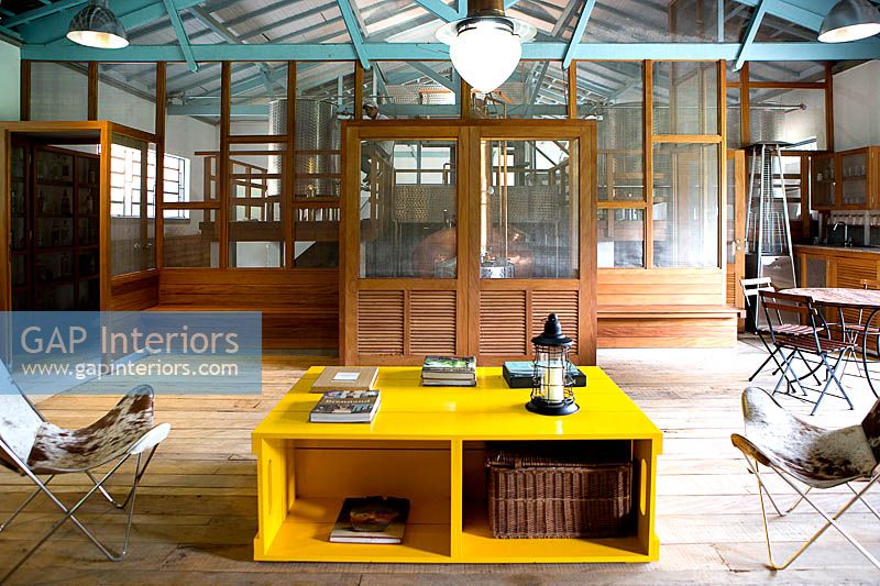 Open plan seating area with yellow coffee table