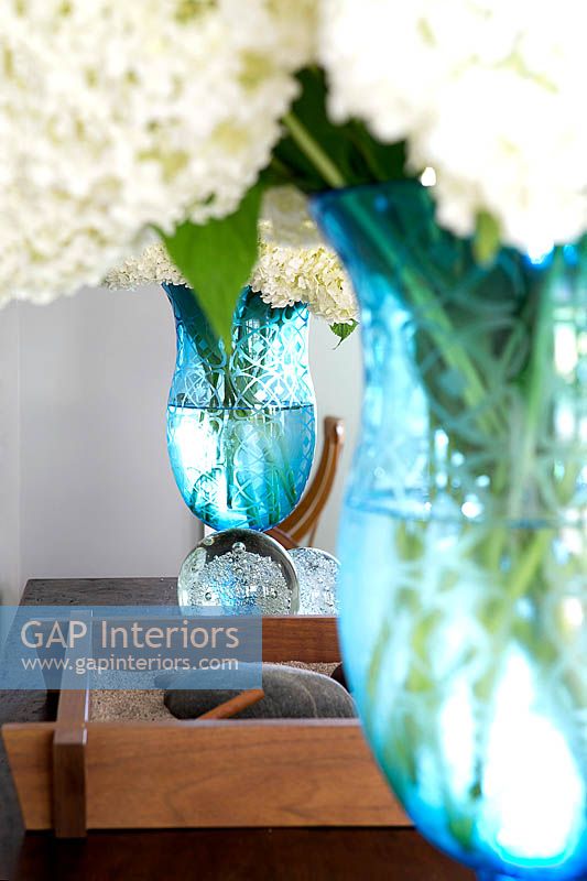 Turquoise vases with white flowers