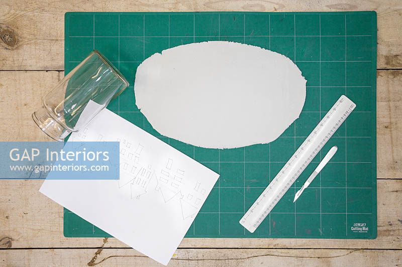 Materials for making clay lanterns - Modelling clay, glass jar, ruler, scalpel and a cityscape outline