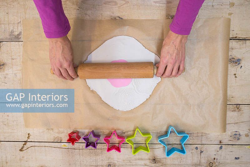 Making clay stars - Lay the silicone flower mould on top of the modelling clay, and gently use the rolling pin to add a light impression from the mould