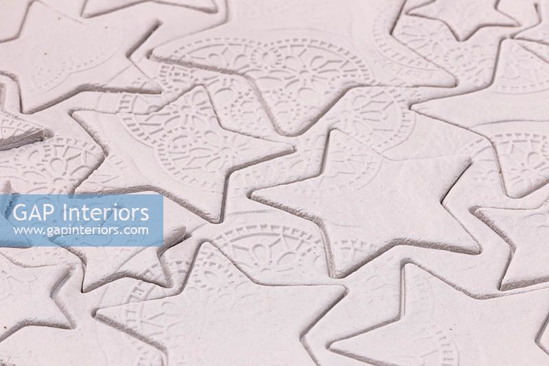 Making clay stars - a variety of different sized stars cut out from the modelling clay showing the silicone mould pattern
