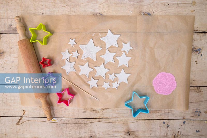 Making clay stars - A variety of different sized stars cut out from the modelling clay, with small holes added for hanging 
