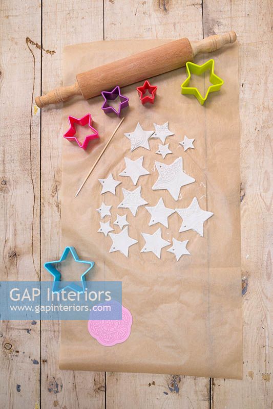 Making clay stars - A variety of different sized stars cut out from the modelling clay, with small holes added for hanging 