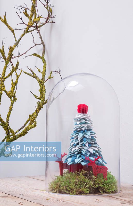 A christmas tree decoration made from wire and coloured felt with moss and felt reindeers