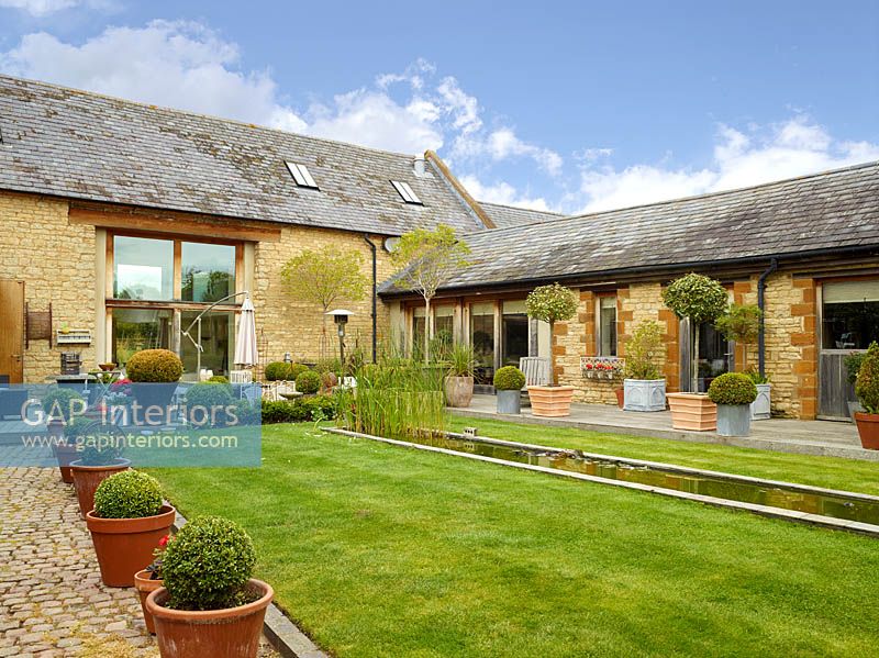 Barn conversion and lawned garden with topiary