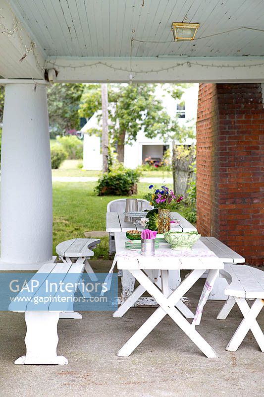 Covered patio with white furniture