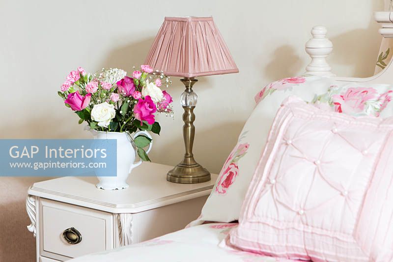 Jug of Roses and Carnations on bedside cabinet