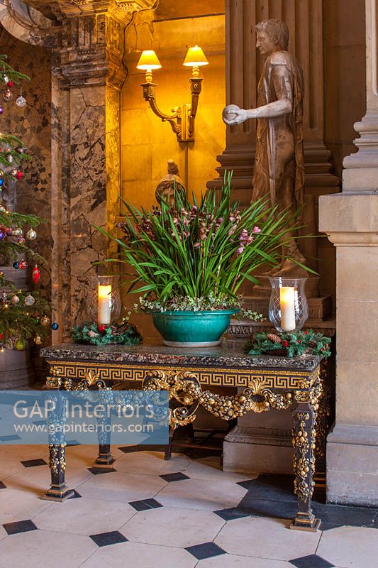 Christmas decorations and potted orchid in the great hall, Castle Howard