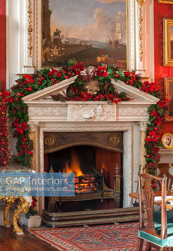 The fireplace in the crimson dining room decorated for christmas, Castle Howard