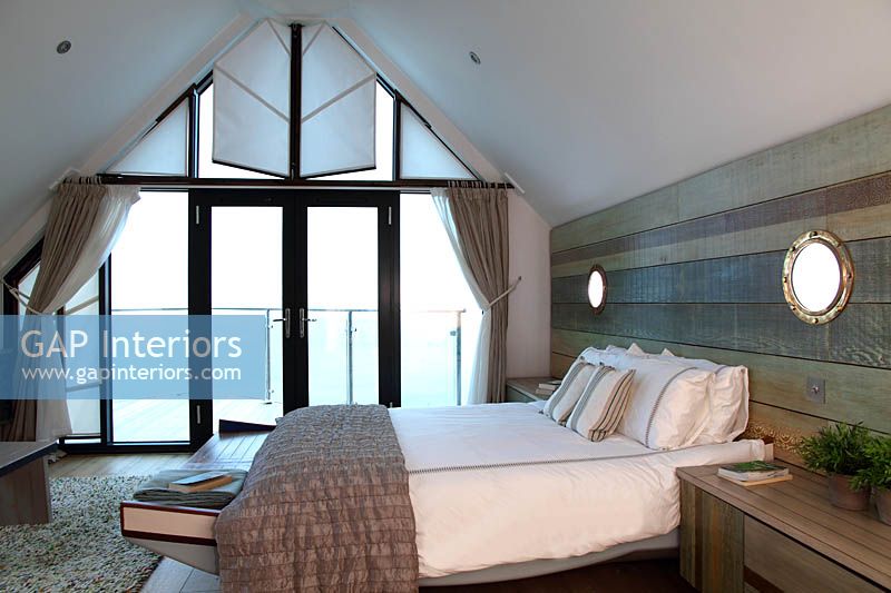 Coastal style bedroom with balcony