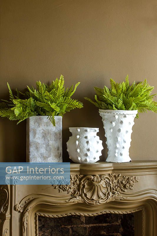 Faux houseplants in white pots