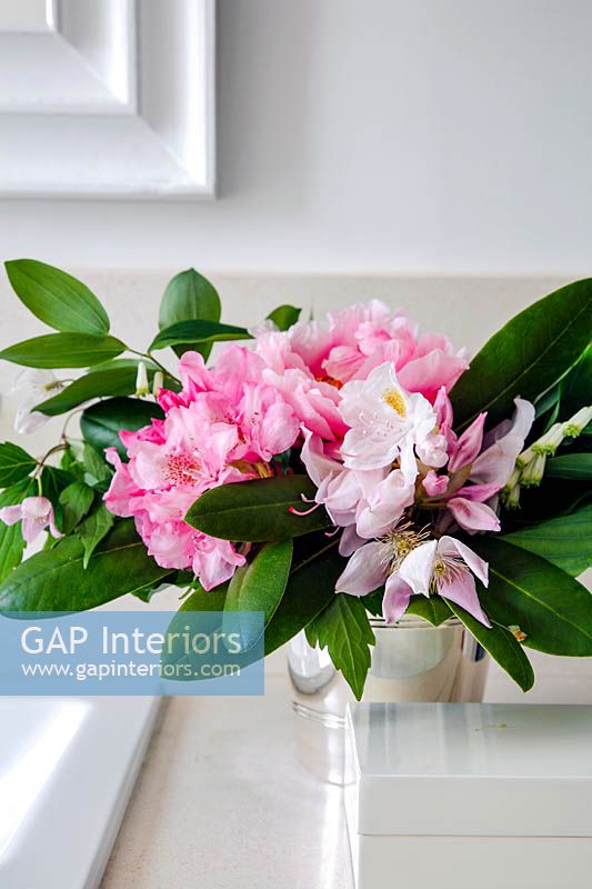 Rhododendron and Clematis flowers in metal pot