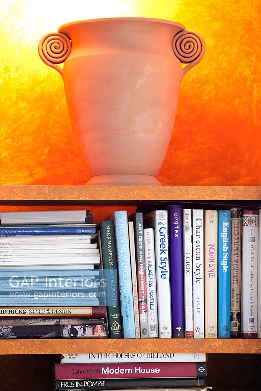 Terracotta urn on bookcase