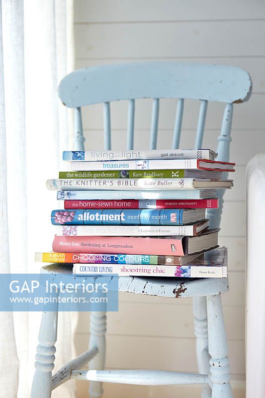 Stack of books on blue chair