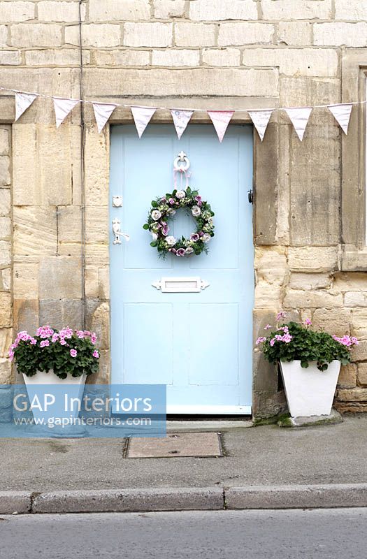 Cottage front door with floral wreath