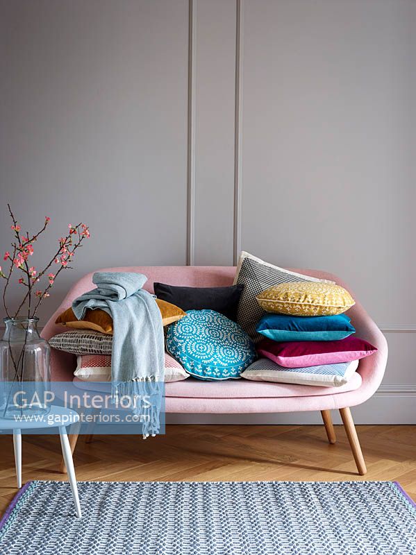 Cushions on pink sofa