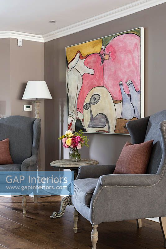 Modern painting and classic armchairs