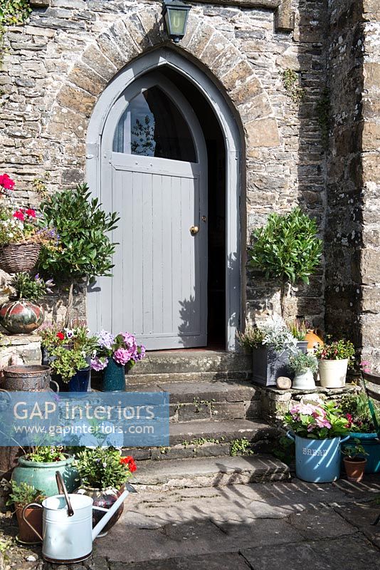 Colourful plants around cottage door