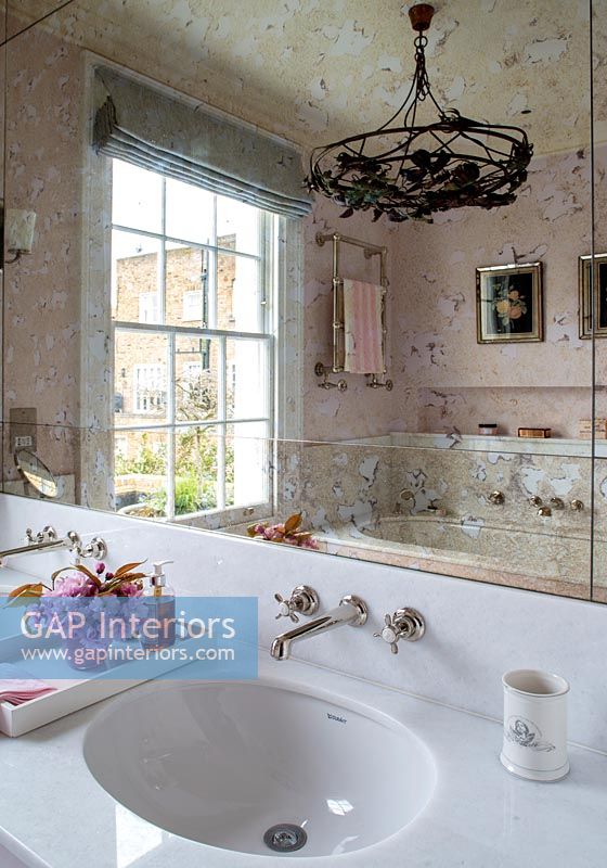 Classic bathroom sinks and antiqued glass mirror