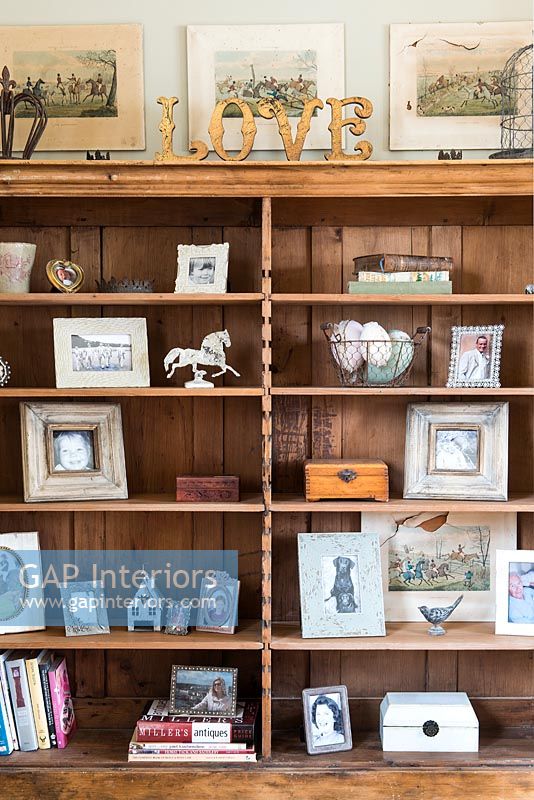 Photo display on wooden shelves