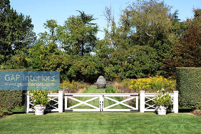 White gate in country garden