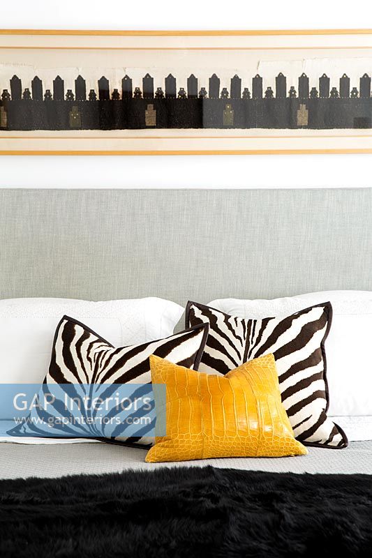 Zebra print cushions on bed