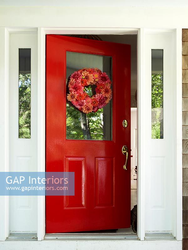 Red front door with floral wreath