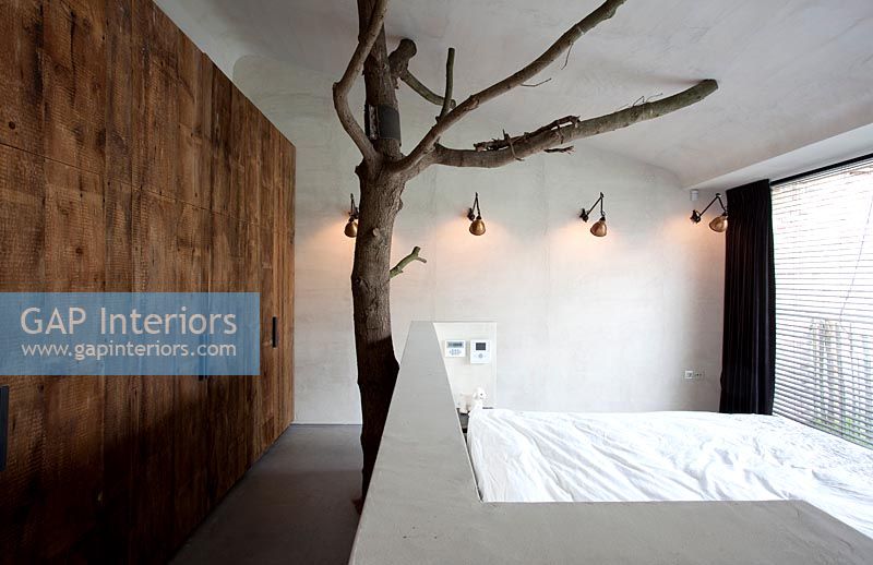 Bedroom with tree sculpture