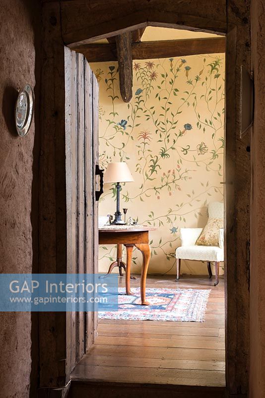 View from hallway into room with handpainted floral design on the walls by Arabella Arkwright - Cothay Manor