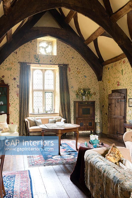 The Great chamber with handpainted floral wall design by Arabella Arkwright and antique furniture - Cothay Manor