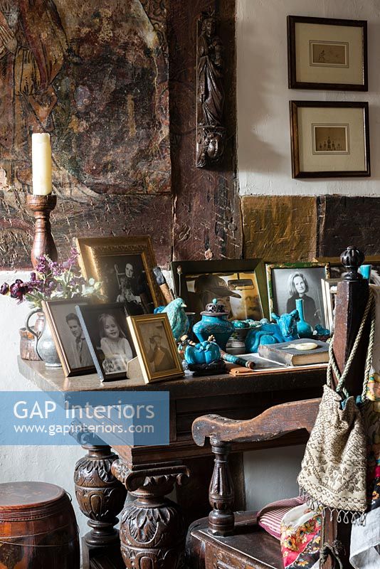 Display of family photos on antique oak table - Cothay Manor